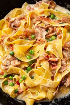 a skillet filled with pasta and peas