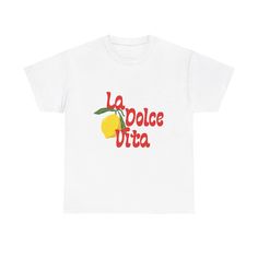 Live La Dolce Vita: Wearing the "La Dolce Vita" Lemon T-Shirt is more than just a fashion choice; it's a celebration of the sweet life, a reminder to savor every moment, and a tribute to the beauty of the Amalfi Coast. It's for the girls who appreciate vintage charm, who love the romance of Italy, and who know that true style is all about effortless elegance. Our t-shirt features the phrase "La Dolce Vita" in a beautifully scripted font, paired with a vibrant lemon illustration that captures the Travel Aesthetic Vintage, Italian Summer Style, Lemon Illustration, Amalfi Coast Travel, The Amalfi Coast, Statement Tees, Girls Wardrobe, Effortless Elegance, Sweet Life