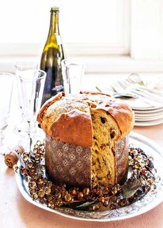 a loaf of bread sitting on top of a plate next to a bottle of wine