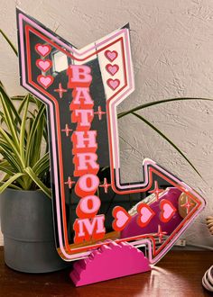 a neon sign that says i love bah - chom with hearts on it