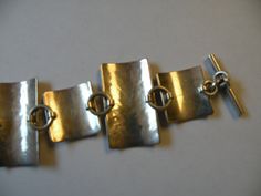 "Sterling silver Modernist Hammered Chain Toggle bracelet Marked - 925 37.8 grams All bracelet 6 7/8\", wearable length 5 5/8\" Very good to excellent condition. It is tarnished, will leave cleaning to the buyer." Silver Rectangular Metal Bracelets, Silver Rectangular Links For Jewelry Making, Silver Metal Chain Bracelet With Polished Finish, Hallmarked Silver Metal Chain Bracelet, Silver Rectangular Chain Bracelet, Modern Silver Bracelets With Clasp, Silver Chain Bracelet With Toggle Clasp For Formal Occasions, Polished Finish Sterling Silver Rectangular Bracelet, Rectangular Silver Chain Bracelet With Polished Finish