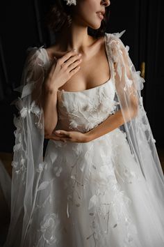 a woman wearing a wedding dress and veil