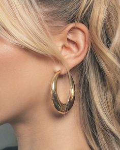 Turn heads no matter where you are! These sleek open hoop earrings are sure to add shine to all of your favorite looks. Available in gold and silver tones. Materials: 14K gold or rhodium plated brass Features: 2.1" hoop, 0.2-0.5" thickness, Lead & Nickel free, post back 60s Hoop Earrings, Gold Hoop Earrings Chunky, Large Hoop Earrings Aesthetic, Chunky Gold Jewelry Earrings, Gold Earrings Chunky, Gold Jewelry Hoops, Hoco Jewelry Gold, Earing Aesthetic, Gold Hoop Earrings Aesthetic