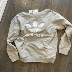 Light Grey Hoodie With White Adidas Logo- Size Medium Hooded Sweatshirt With Logo Print For Spring, Athleisure Logo Print Sweatshirt For Spring, Spring Athleisure Sweatshirt With Logo Print, Casual Sports Sweater With Drawstring Hood, Casual Sweater With Drawstring Hood For Sports, Adidas Athleisure Hoodie With Crew Neck, Casual Hoodie With Logo Print For Fall, Casual Fall Hoodie With Logo Print, Cozy Sports Hoodie For Spring