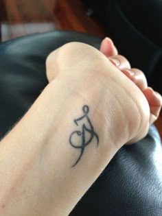 a person with a tattoo on their wrist