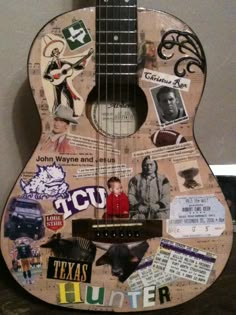 a guitar with many pictures and words on it