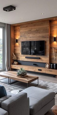 a living room filled with furniture and a flat screen tv mounted on the wall above it