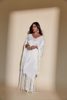 SOL FRINGE KAFTAN - OFF WHITE – Kadimah Elegant White V-neck Kaftan, Festival V-neck Maxi Dress With Tassels, V-neck Maxi Dress With Tassels For Festival, Elegant Long Sleeve Kaftan With Tassels, Chic White V-neck Kaftan, White Maxi Dress With Long Sleeves And Tassels, White Long Sleeve Maxi Dress With Tassels, Spring Maxi Kaftan With Tassels, White Fringe V-neck Dress