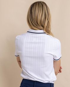 Polish up your wardrobe with the Shaylyn Active Polo. This short-sleeve top features contrasting line detailing on the ribbed collar and cuffs. The invisible zipper adds to the streamlined silhouette, and the flattering style ensures you look your best on the course. Move in comfort with the stretch-infused material of this versatile polo. Pair with our Chapel Performance Pant to complete the look. Style: 11190 Classic Short Sleeve Tops With Striped Cuffs, White Polo Collar Top With Striped Cuffs, White Top With Contrast Collar, Classic White Top With Striped Collar, Classic White Tops With Striped Collar, White Polo Top With Striped Collar, White Polo Collar Top With Striped Collar, Sporty White Tops With Striped Cuffs, Summer Polo Top With Contrast Collar