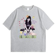 a grey t - shirt with an image of a woman sitting on the ground and butterflies around