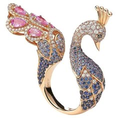 Peacok ring in 18kt pink gold set with 236 diamonds 1.69 cts, 6 pink pear-shaped sapphires 2.37 cts, 201 blue sapphires 3.39 cts and 2 black diamonds 0.04 cts Size 54 Flower Ring Design, Fancy Diamond Ring, Peacock Ring, Peacock Jewelry, Bijoux Art Nouveau, Diamond Gold Ring, Jewellery Design Sketches, Fancy Rings, Jewelry Designing