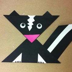 a black and white cat made out of paper