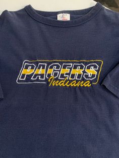 Vintage Indiana Pacers T Shirt Size Medium See pics for measurements Quality Embroidered Heavy 100% Cotton material Unique design Fine condition Fast shipping. We ship same or next day with USPS We are a small family business and we appreciate your purchase, Godspeed ! Blue College T-shirt With Embroidered Logo, Casual Embroidered Graphics T-shirt For Fans, Casual T-shirt With Embroidered Graphics For Fans, Navy Top With Embroidered Logo For College, Vintage Embroidered Cotton T-shirt, Vintage Cotton Top With Embroidered Logo, Collegiate Cotton T-shirt With Embroidered Graphics, Fan Apparel Cotton T-shirt With Embroidered Graphics, Cotton College T-shirt With Embroidered Graphics