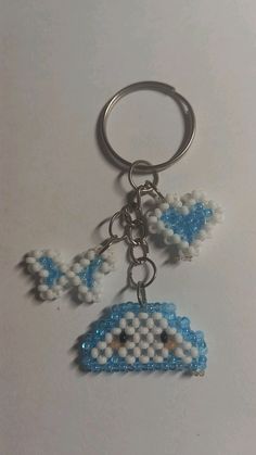 a blue and white beaded keychain hanging from a metal ring