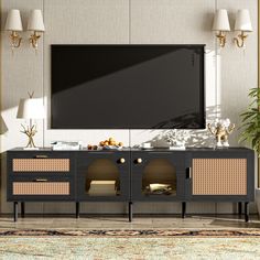 an entertainment center with a flat screen tv mounted on it's sideboard in a living room