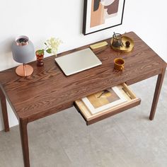 a wooden desk with a laptop on it