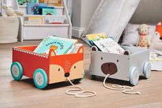 two children's books are in a wooden box on the floor next to each other