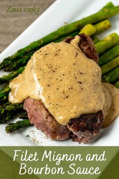 a plate topped with steak and asparagus covered in gravy