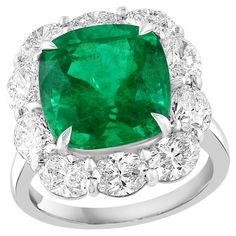 A stunning well-crafted engagement ring showcasing a 6.58-carat certified cushion-cut vivid green emerald. Flanking the center diamond are perfectly matched oval cut 10 diamonds weighing 3.05 carat in total, set in a polished platinum mounting. Handcrafted in our New York City workshop. Green Emerald is approx 11.65 x 11.40 x 8.15 mm. Style is available in different price ranges. Prices are based on your selection. Please contact us for more information. Luxury Green Emerald Ring With Vvs Clarity, Luxury Green Emerald Diamond Ring, Luxury Vvs Clarity Emerald Fine Jewelry Ring, Luxury Green Diamond Ring, Exquisite Style, Luxury Green Brilliant Cut Gemstones, Emerald Diamond Ring, Cushion Cut Ring, American Modern, Green Emerald