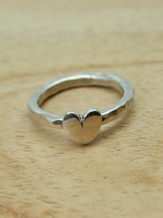 Sterling silver heart ring. This chunky heart ring  has been created in our own studio in Cornwall. The heart is hand saw pierced and sits on a hammered silver band. Looks great and is very comfortable to wear. UK finger sizes  J to T Other sizes  on request    All my jewellery comes in a presentation gift box.  All my designs are hand made and no two are exactly the same.   Thank you for visiting. Cute Silver Heart Ring For Valentine's Day, Unique Heart Shaped Jewelry For Promise, Unique Heart Shaped Promise Jewelry, Unique Heart-shaped Promise Jewelry, Handmade Cute Promise Ring, Cute Handmade Promise Ring, Heart-shaped Sterling Silver Stackable Rings, Handmade Cute Sterling Silver Rings, Handmade Open Heart Promise Ring