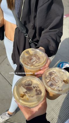 two people holding up drinks in their hands