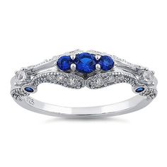 Top of ring height: 6mm

Band width: 1.9mm

Shank width: 1.6mm


 



Stone material: blue & clear cubic zirconia



Center stone size: 3.2mm



Stone size: round cut



Center stone carat weight: .11 ct



Total number of CZ stones: 29



Stone setting: prong setting



 



Metal: 925 sterling silver



Plating: rhodium plated 



Finish: high polish Blue Rings With Side Stones And Round Cut, Elegant Blue Cubic Zirconia Stackable Rings, Blue Round Cut Rings With Side Stones, Sapphire Cluster Ring With Cubic Zirconia In Round Cut, Sapphire Cluster Ring With Center Stone In Cubic Zirconia, Blue Cubic Zirconia Cluster Ring With Brilliant Cut, Blue Brilliant Cut Cubic Zirconia Cluster Ring, Blue Cubic Zirconia Cluster Ring Round Cut, Blue Cubic Zirconia Rings With Diamond Accents