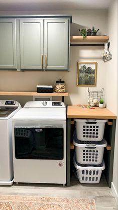 a washer and dryer in a small room next to some cabinets with drawers