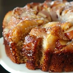 a bundt cake on a white plate covered in icing and cinnamon swirls