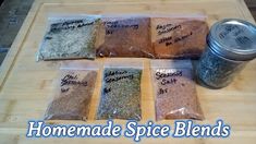 four bags of spices sitting on top of a cutting board