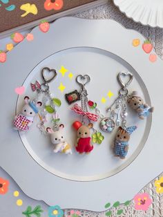 several keychains are arranged on a plate