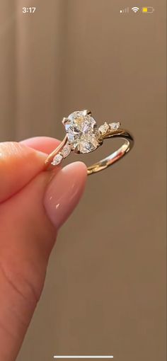 a person holding a diamond ring in their hand