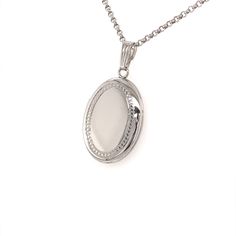 Keep your treasure close to your heart in this 17x20mm oval locket pendant. It is set in sterling silver with a beaded edge and hangs from an 18" rolo chain.