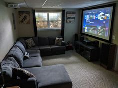 a living room filled with furniture and a flat screen tv mounted to the side of a wall