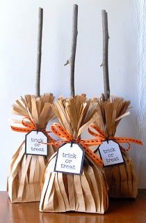 three bags with tags tied to them sitting on a table next to some sticks and twig