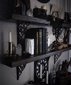 some shelves with books and candles on them