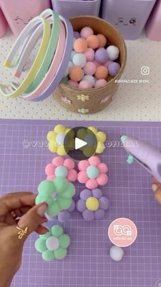 someone is decorating small balloons in pastel colors