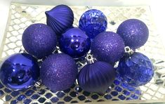 purple and blue glass ornaments in a bowl