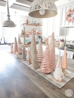 the kitchen counter is decorated with pink and white christmas trees