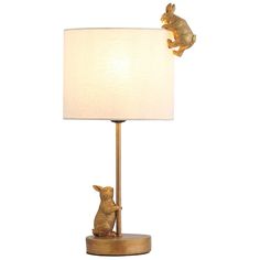 a lamp that has two rabbits on it