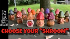 a group of small wooden gnomes sitting on top of a cement ground next to a tree