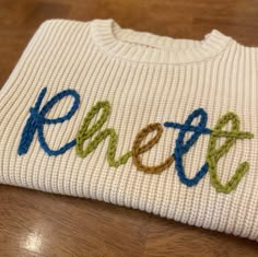 Get a perfectly cozy sweater with your child's name hand embroidered on it. A lovely gift for a birthday, Christmas, or for anytime through the winter! Custom made to order within 3 business days. To personalize: write child's name in the NAME box on this page before adding to your shopping cart. Specify if for girl or boy. Select three colors of yarn from our color chart. Example: Rhett- boy- teal, green apple, tobacco Infant sizes are oversized sweaters, size down if looking for a true to size Embroider Baby Sweater, Hand Embroidered Blanket, Embroidering Clothes, Embroidered Name Sweater, Embroidered Baby Sweater, Hand Embroidered Name, Valentines Embroidery Designs, Name Sweater, Sweater Designs