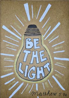 a drawing of a light bulb with the words be the light written below it on brown paper