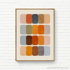 an art print on a brick wall with different shades of oranges, browns and browns