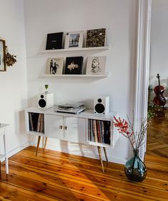 a white entertainment center with record players on it