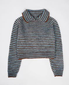 a blue and brown striped sweater on a white surface with the hood pulled up to show it's long sleeves