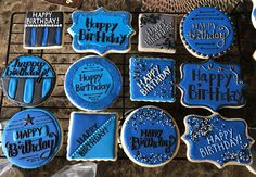 blue decorated cookies on a cooling rack with happy birthday written on the top and bottom