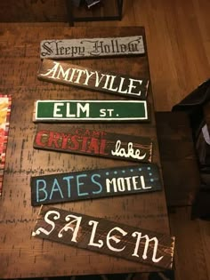 wooden signs are displayed on a table in a room with wood flooring and walls