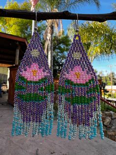 Very pretty beaded earrings with a beautiful pink lotus flower and water scenery within the design. The colors are vibrant and soothing to see! These are light weight and simple exquisite.  You can choose different colors for the lotus flower :) Lotus Beaded Earrings, Purple Beaded Fringe Earrings For Festivals, Bohemian Flower Earrings With Dangling Beads, Bohemian Dangle Flower Earrings For Beach, Bohemian Flower Earrings For Beach, Bohemian Turquoise Beaded Flower Earrings, Purple Bohemian Beaded Tassel Earrings, Bohemian Pink Flower Earrings With Dangling Beads, Bohemian Purple Beaded Tassel Earrings