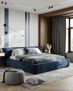 a large blue bed sitting in a bedroom next to a window