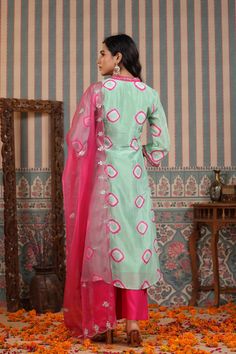 A timeless wardrobe essential, this mint green suit set is crafted from muslin fabric and features handwork that is sure to captivate. Accompanied with an organza dupatta, this set exudes elegance and sophistication. Relaxed enough for every day and luxurious enough for special occasions, this is an exclusive piece that will never go out of style. No. of pieces - 3 piece set. Color - Green and Pink. Fabric - Muslin. Washing Instructions - Dry Clean.